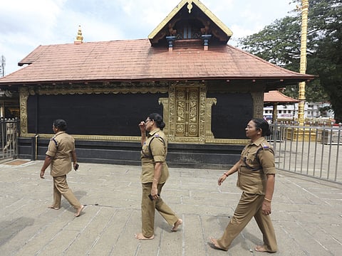 Police woman, above the age of 50, who have been deployed for security circumambulate the main shrine at the Sabarimala temple, one of the world's largest Hindu pilgrimage sites, in the southern Indian state of Kerala, Monday, Nov. 5, 2018.