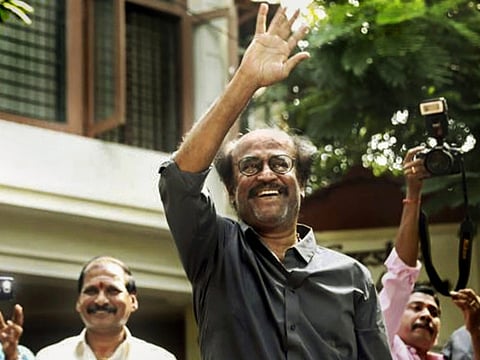 File photo: Actor-turned-politician Rajinikanth waves as he greets his fan on the eve of 'Diwali' at his residence, in Chennai, Tuesday, Nov. 6, 2018.  