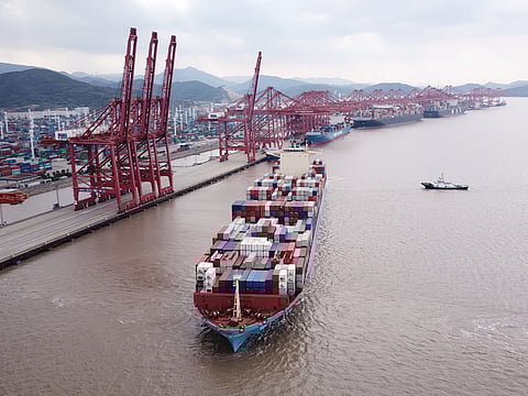 A container ship is pulled by tug boats at the Port of Ningbo-Zhoushan in Ningbo, China. The shutdown at Ningbo-Zhoushan is raising fears that ports around the world will soon face the same kind of outbreaks and Covid restrictions that slowed the flows of everything from perishable food to electronics last year.