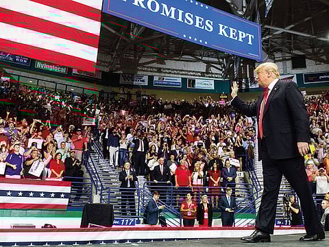 US President Donald Trump waves to the crowd during a campaign rally in Estero, Florida, for the US midterm elections. Both Trump, a Republican, and former president Barack Obama, a Democrat, are barnstorming the country ahead of the elections, in which Democrats hope to win control of the House of Representatives, gain Senate seats and pick up governor's mansions and state legislatures across America.