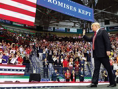 US President Donald Trump waves to the crowd during a campaign rally in Estero, Florida, for the US midterm elections. Both Trump, a Republican, and former president Barack Obama, a Democrat, are barnstorming the country ahead of the elections, in which Democrats hope to win control of the House of Representatives, gain Senate seats and pick up governor's mansions and state legislatures across America.