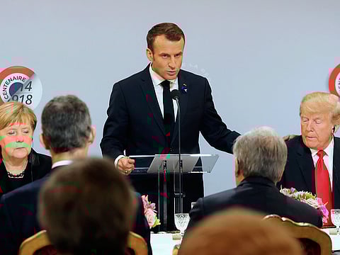 German Chancellor Angela Merkel and President Donald Trump listen to French President Emmanuel Macron delivering a speech before a lunch at the Elysee Palace in Paris during commemorations marking the 100th anniversary of the 11 November 1918 armistice, ending First World War, Sunday, November 11, 2018 