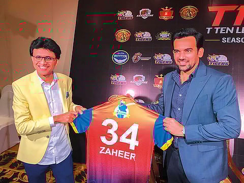 Anis Sajan presents team jersey to Zaheer Khan at a promotional event.
