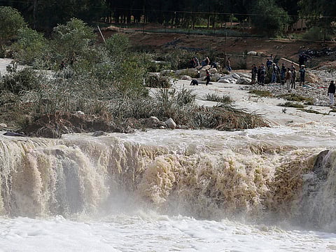 Civil defense members look for missing people after rain storms unleashed flash floods, in Madaba city