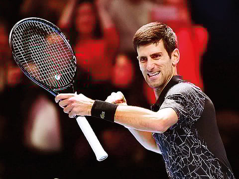 Novak Djokovic celebrates after winning against John Isner during their men’s singles round-robin match on Monday.