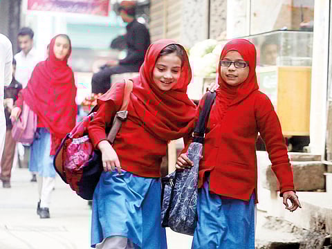 Girls leave their school in Peshawar, Pakistan, Tuesday, Nov. 13, 2018.
