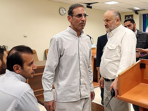 File photo: Vahid Mazloumin (centre) is seen appearing in court for the first time on charges of manipulating the currency market. 
