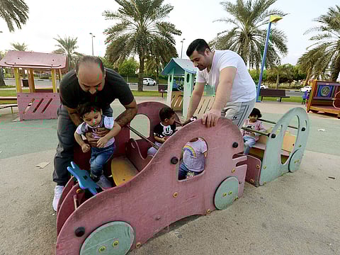 Parents help their children play at the Family Park in Abu Dhabi Corniche. 