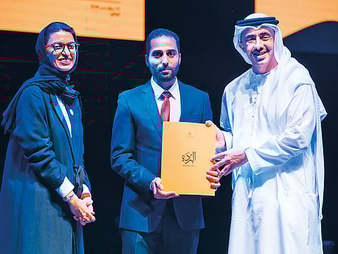 Shaikh Abdullah honouring a winner of the Al Burda Award during a ceremony at NYU Abu Dhabi. Noora Mohammad Al Kaabi is present.