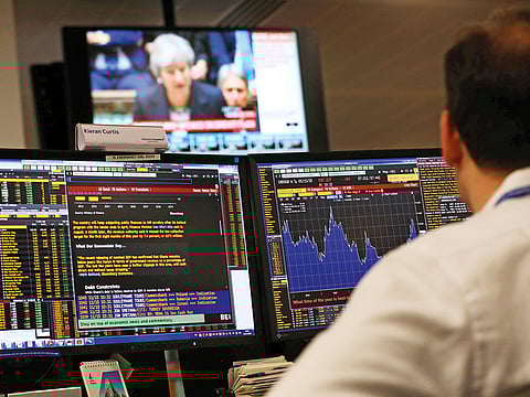 An investment manager watches Britain’s Prime Minister, Theresa May, deliver a statement to the House of Commons, in London yesterday. London’s financial services sector too is not convinced about the deal given the political certainty.