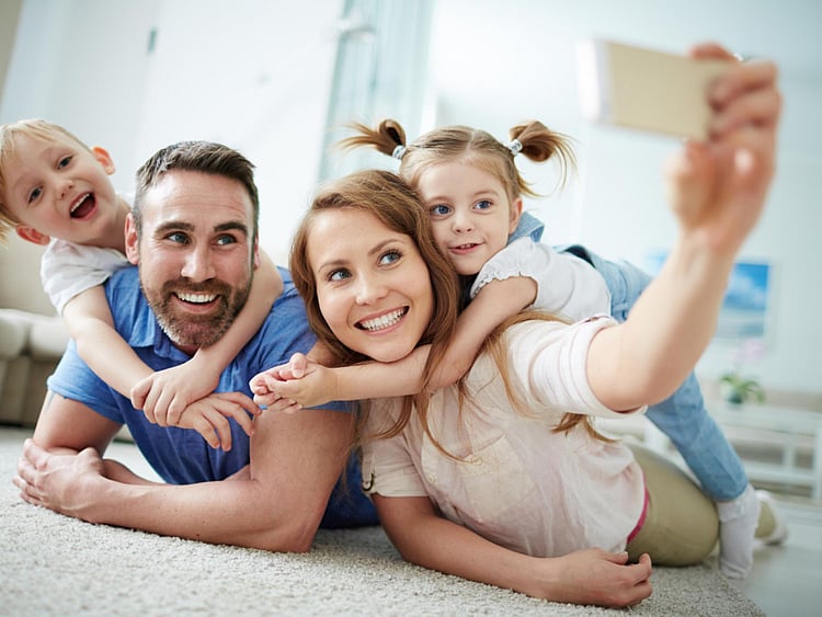 woman clicking pictures of children