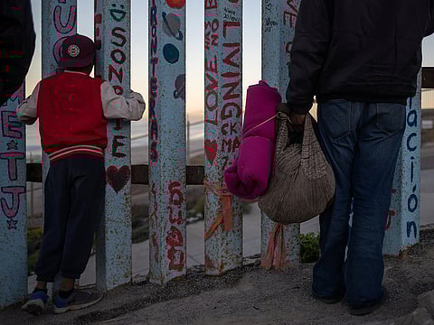 Migrants, part of a caravan of thousands from Central America trying to reach the U.S., look towards the United States past the border fence in Tijuana, Mexico November 15, 2018.