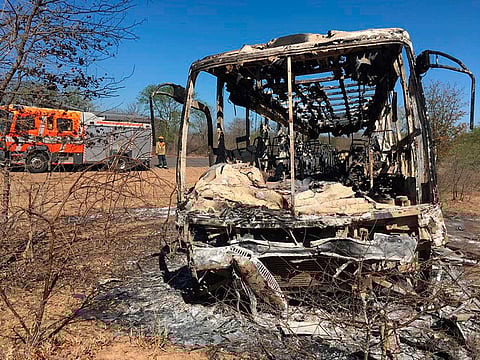 A fire engine is parked near to a burnt out bus in Gwanda about 550 kilometres south of the capital Harare. 