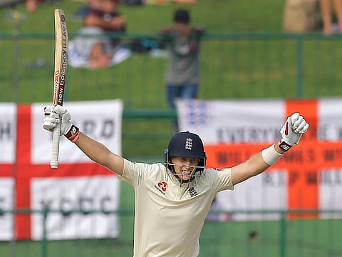 England's Joe Roots celebrates as he takes a run completing a century during the third day of the second test cricket match between Sri Lanka and England in Pallekele, Sri Lanka.