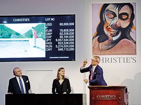 The auctioneer takes bids for the sale of David Hockney’s painting during the auction at Christie’s in New York.