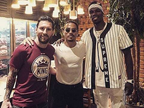 Footballers Lionel Messi and Paul Pogba with Nusret Gökçe.