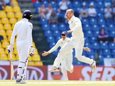 England’s Jack Leach celebrates the dismissal of Sri Lanka’s Dhananjaya de Silva during the fourth day of the second Test at the Pallekele International Stadium in Kandy yesterday.