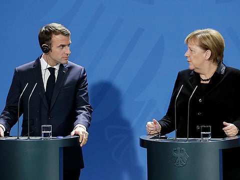 German Chancellor Angela Merkel, right, and France's President Emmanuel Macron, left, address the media during a joint statement prior to a meeting at the chancellery in Berlin, Germany, Sunday, November 18, 2018.