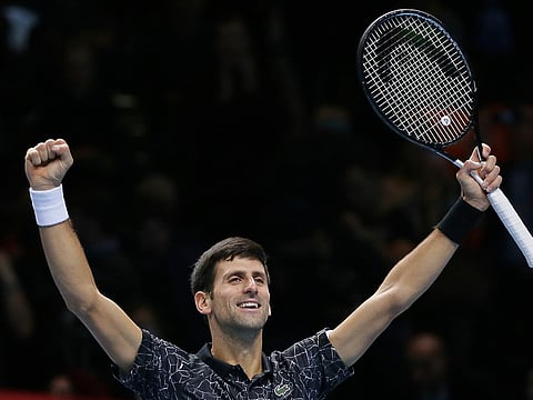 Novak Djokovic of Serbia celebrates winning match point against Kevin Anderson of South Africa in their ATP World Tour Finals singles tennis match at the O2 Arena in London, Saturday Nov. 17, 2018