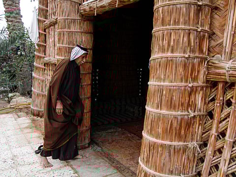 A man enters the straw tent in the town of Mishkhab, south of Najaf.