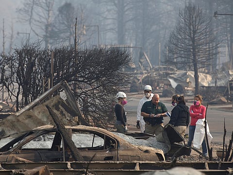Coroners and forensic anthropologists recover human remains from a trailer home destroyed by the Camp Fire in Paradise, California, US, November 17, 2018.  
