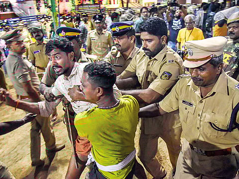 Police personnel detain the devotees who were staging Namajapa protest against the restrictions at Sannidhanam in Sabarimala.