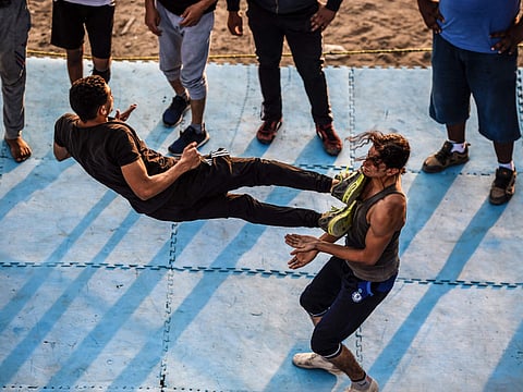Members of the self-declared Egyptian Wrestling Federation train in a ring during a session outside the federation founder’s home in the village of Serapeum in the province of Esmailiya.