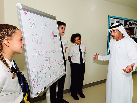 Dr Abdullah Al Karam interacts with Safa Community School students during the well-being census event yesterday.