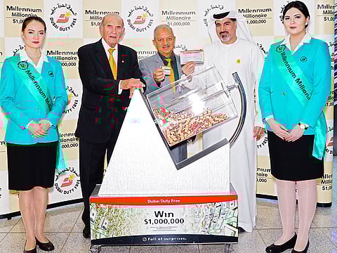 Dubai Duty Free representatives pick the latest winner of Millennium Millionaire draw.