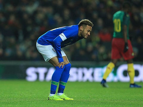 Brazil's Neymar doubles over on the pitch after getting injured.