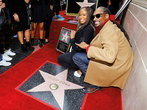 File photo of rapper Snoop Dogg posing for a picture with his wife Shante Broadus.