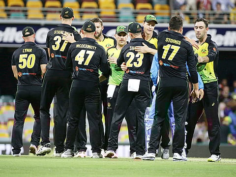 Australia players celebrate after winning the first T20 International cricket match against India in Brisbane, Australia, Wednesday, November 21, 2018. 