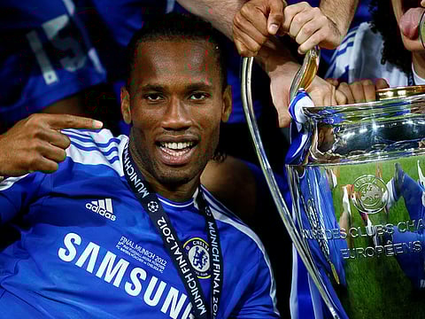 Didier Drogba celebrates with the Champions League trophy.