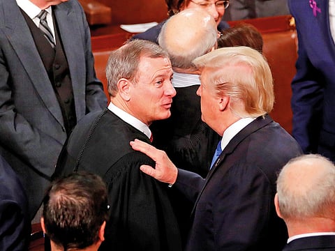 US President Donald Trump (R) talks with US Supreme Court Chief Justice John Roberts as he departs after delivering his State of the Union address to a joint session of the U.S. Congress on Capitol Hill in Washington, U.S. January 30, 2018.