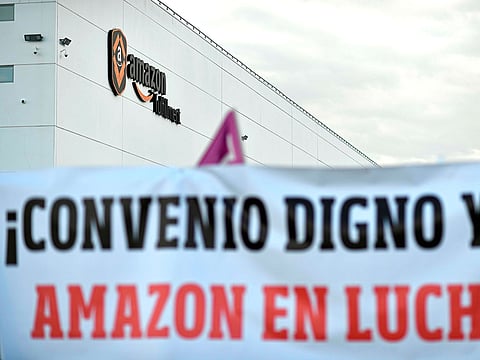 A banner reads "A decent agreement now! Amazon on strike" outside the US electronic commerce and cloud computing company's facilities in San Fernando de Henares, the biggest in Spain, during a strike on November 23, 2018. 