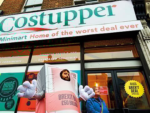 Activists welcome shoppers to the ‘Costupper Brexit Minimart’, a post-Brexit inspired pop-up shop, selling items  with anti-Brexit themed labels and decked out in anti-Brexit posters and signs in south London.