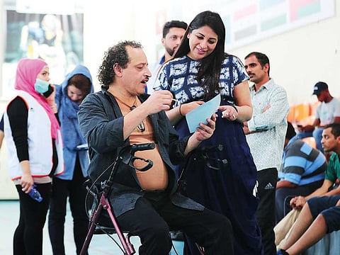 Artist Fawaz Ayoub (left) showcasing his artwork to Alisha Moopen — Executive Director and CEO of Aster and Medcare Hospitals and Clinics.