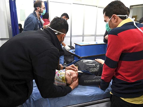 A woman receives treatment at a hospital following a suspected poison gas attack on her town of Al Khalidiya