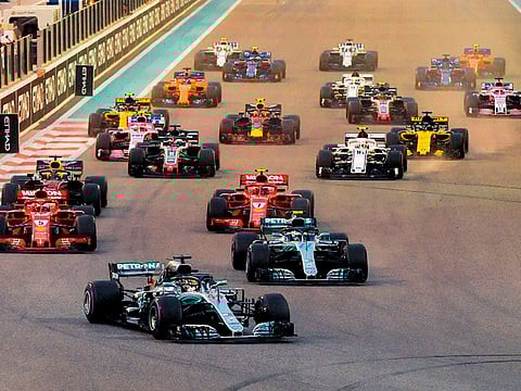 Lewis Hamilton leads the pack at the start of Formula 1 Abu Dhabi Grand Prix at Yas Marina circuit. 