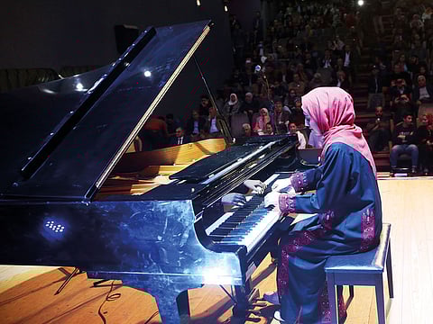 Palestinian pianist Yara Thabit plays the piano during a concert in Gaza City.