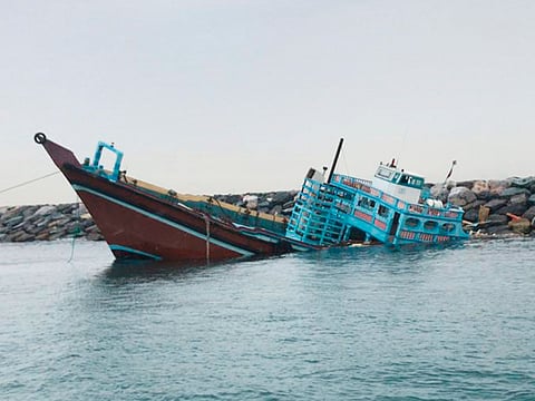 Two of the sailors fell into the sea when the boat capsized.