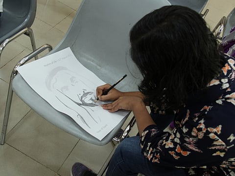 A pupil participates in a summer campaign for children of determination.