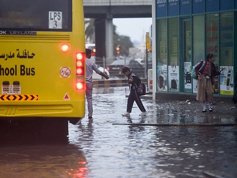 A student boards a school bus after schools cancelled classes on Monday due to heavy rains. 