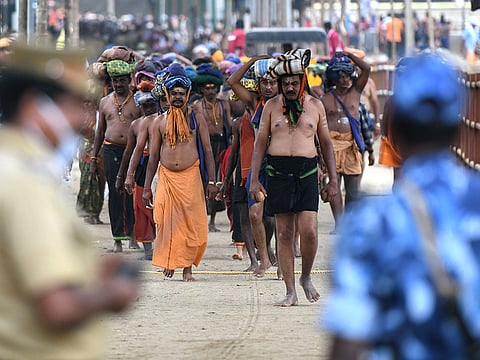 This photo taken on November 18, 2018 shows Indian police standing guard as Indian Hindu devotees trek to the Sabarimala temple in the southern state of Kerala.