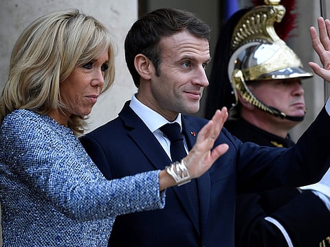 French President Emmanuel Macron (C) and his wife Brigitte Macron in Paris on November 27, 2018