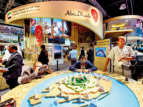 Visitors take a tour of Sir Bani Yas Island in Abu Dhabi using virtual reality during an exhibition in Dubai. VR technology vendors say the experience can be authentic and believable.