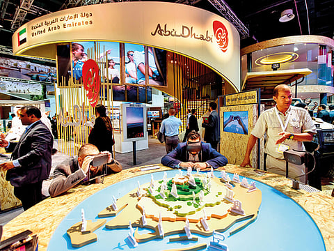 Visitors take a tour of Sir Bani Yas Island in Abu Dhabi using virtual reality during an exhibition in Dubai. VR technology vendors say the experience can be authentic and believable.