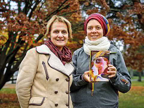 Geneva theology professors Elisabeth Parmentier (left) and Lauriane Savoy pose with an edition of ‘A Women’s Bible’ in Geneva, which was published in October.