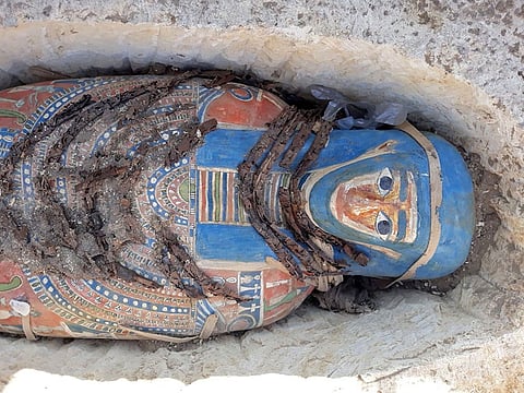 A handout picture released by the Egyptian Ministry of Antiquities on November 28, 2018 shows newly-uncovered mummies dating back over 2,300 years that were found by Egyptian archaeologists at a pyramid complex south of Cairo. 