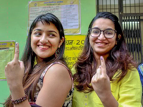 First time voters  show their fingers marked with indelible ink after casting votes for the Assembly elections, at a polling station in Bhopal, Madhya Pradesh, on Wednesday, Nov 28, 2018. 